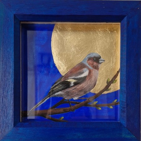 Bird on branch behind golden moon